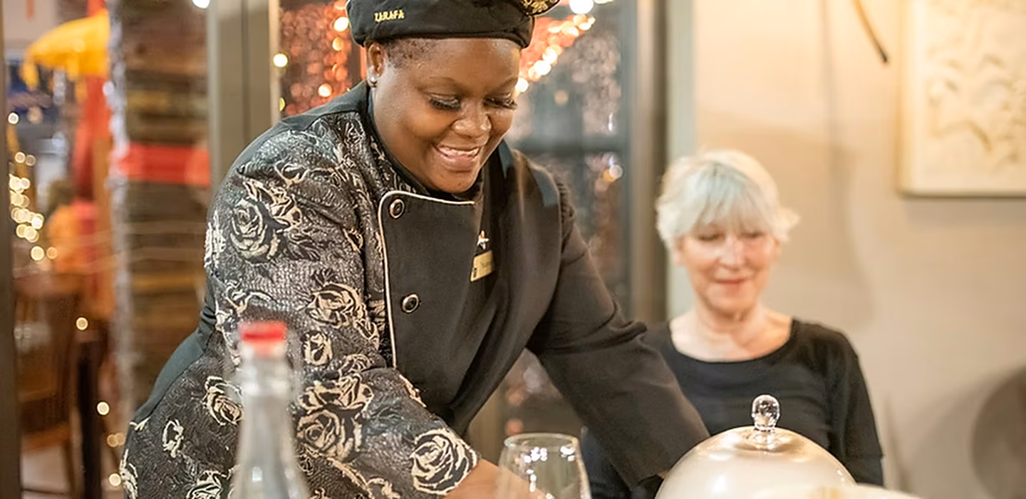 A member of the Zarafa team serving a guest in the restaurant