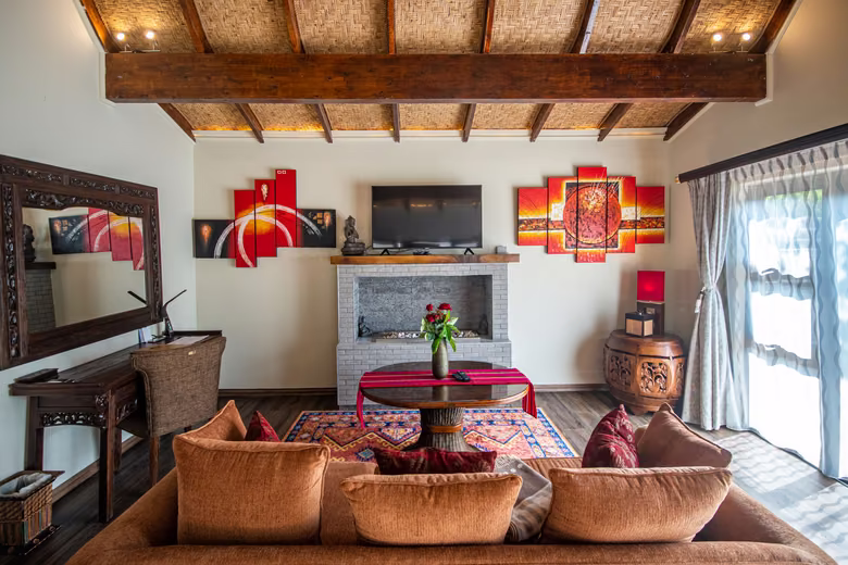 Villa lounge with fireplace beneath a woven ceiling