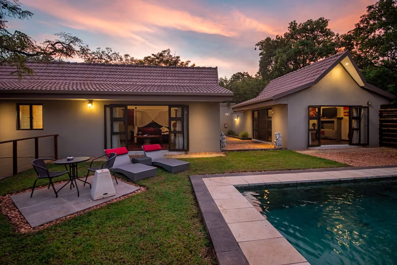 Villa terrace and rim-flow pool at dusk