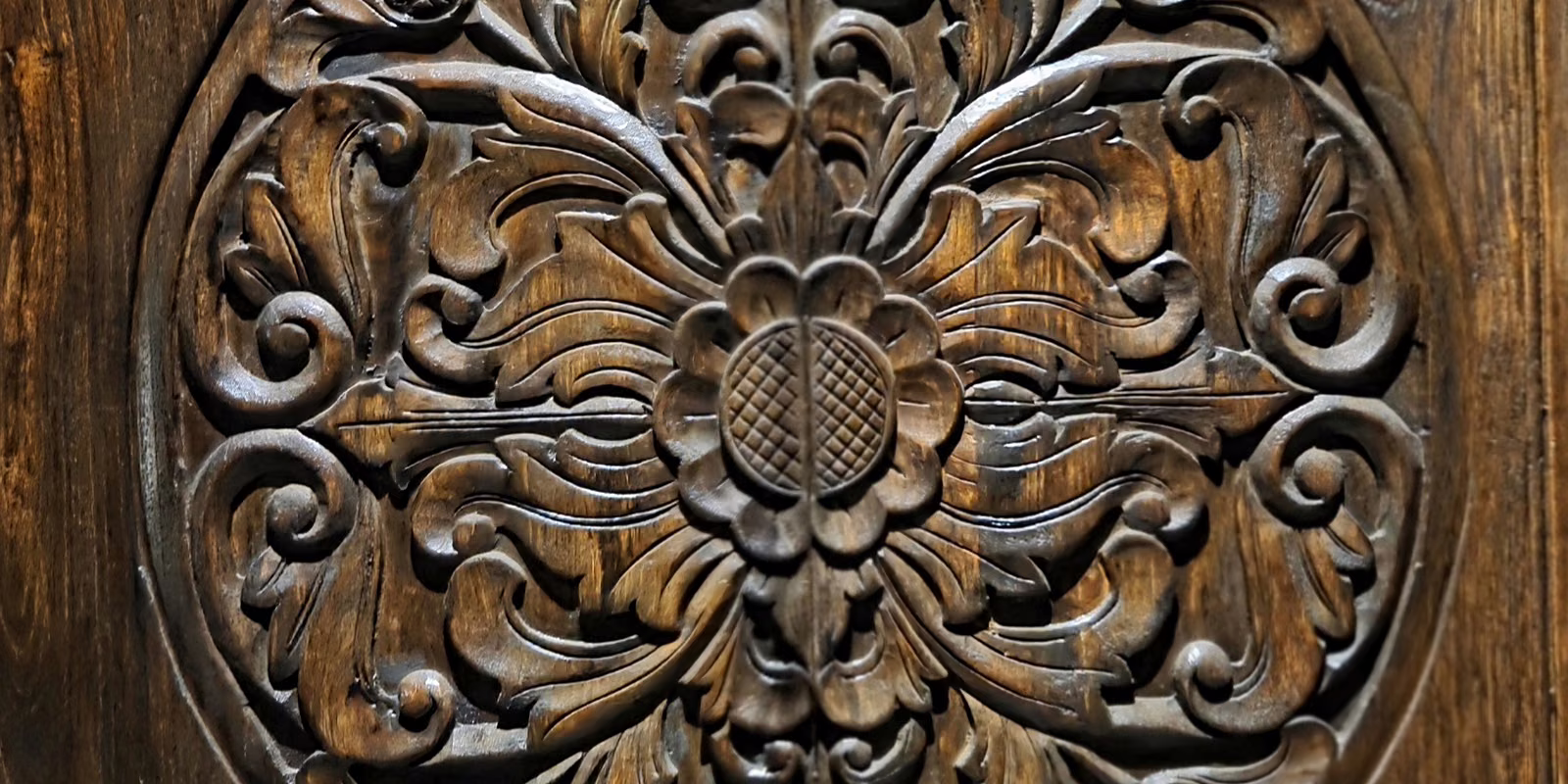 The carved teak medallion on the doors into the lodge