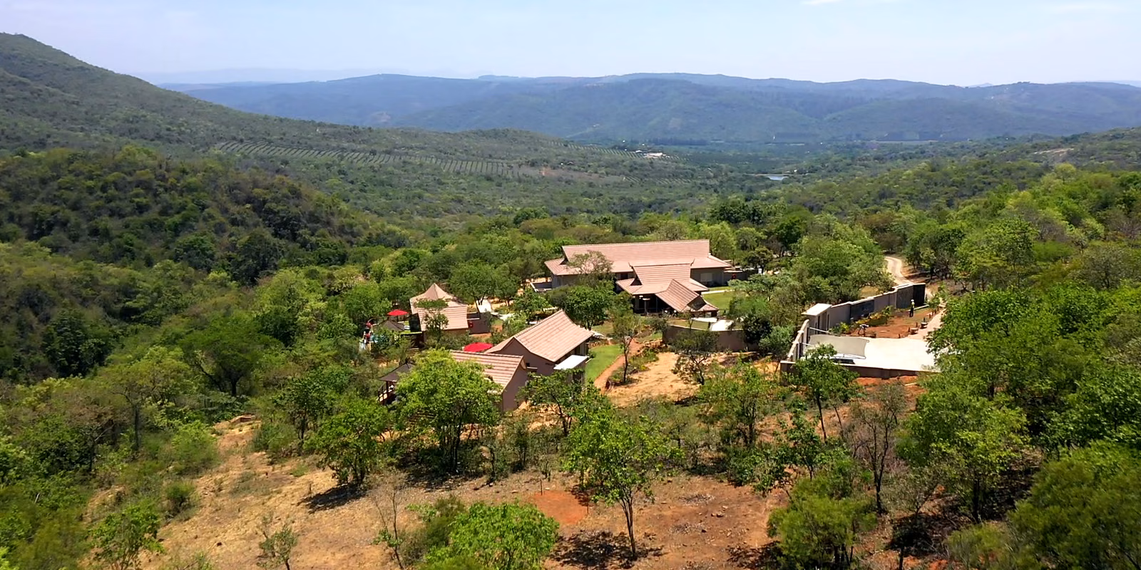 The lodge from above, set in the bush with the Sabie Valley and the hills beyond