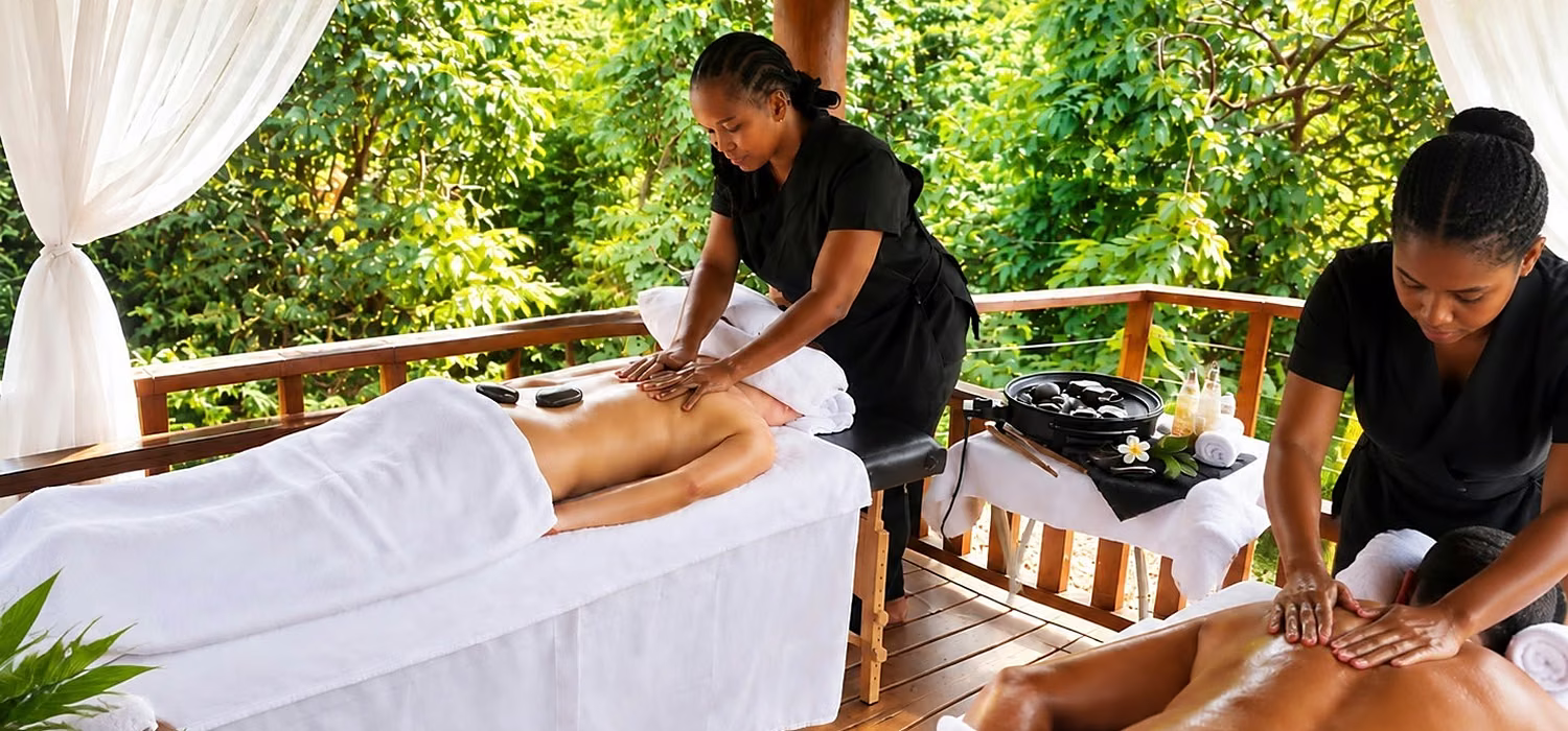 Two therapists giving a hot stone massage side by side in the gazebo